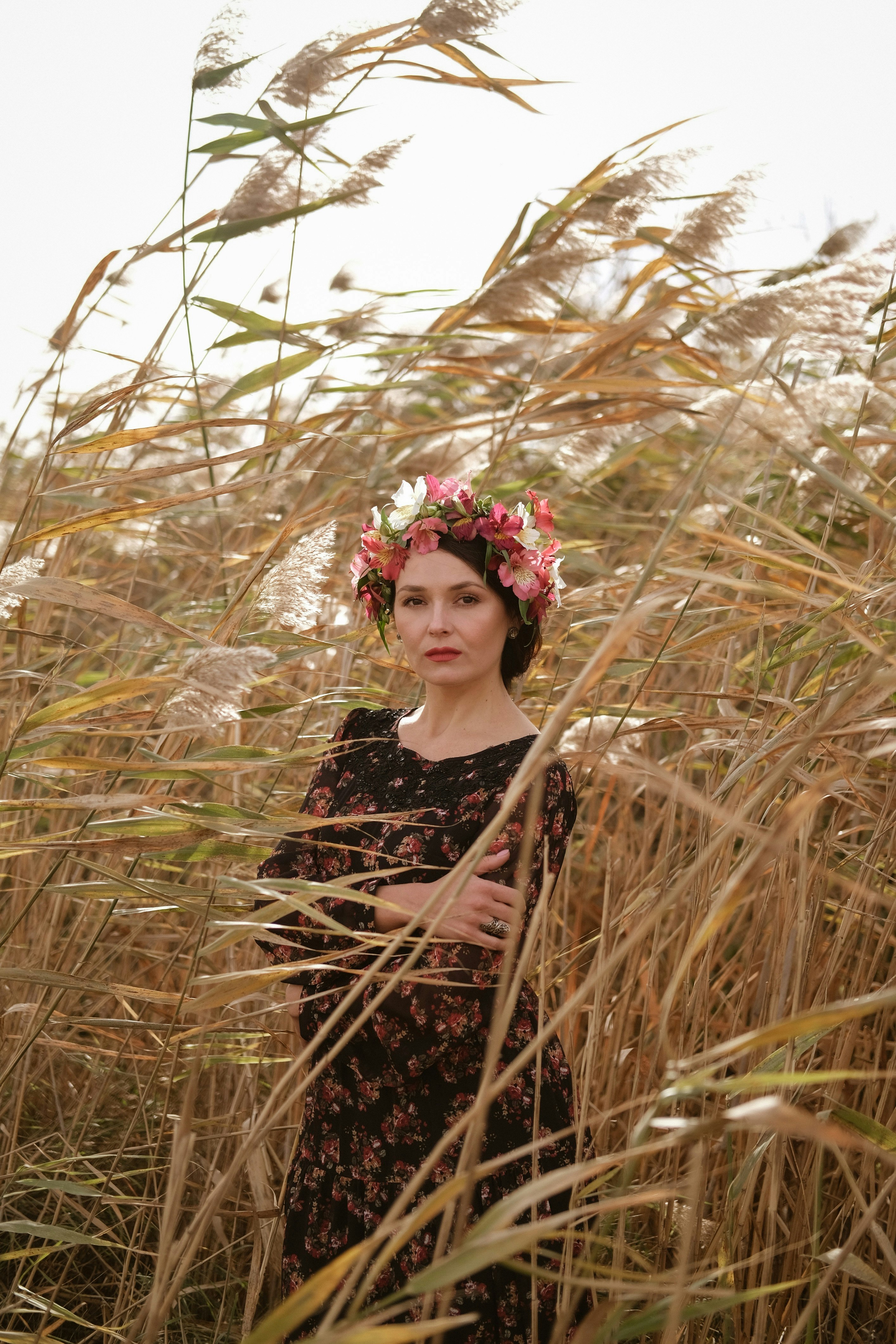 woman in black and brown floral dress wearing red and white floral headdress